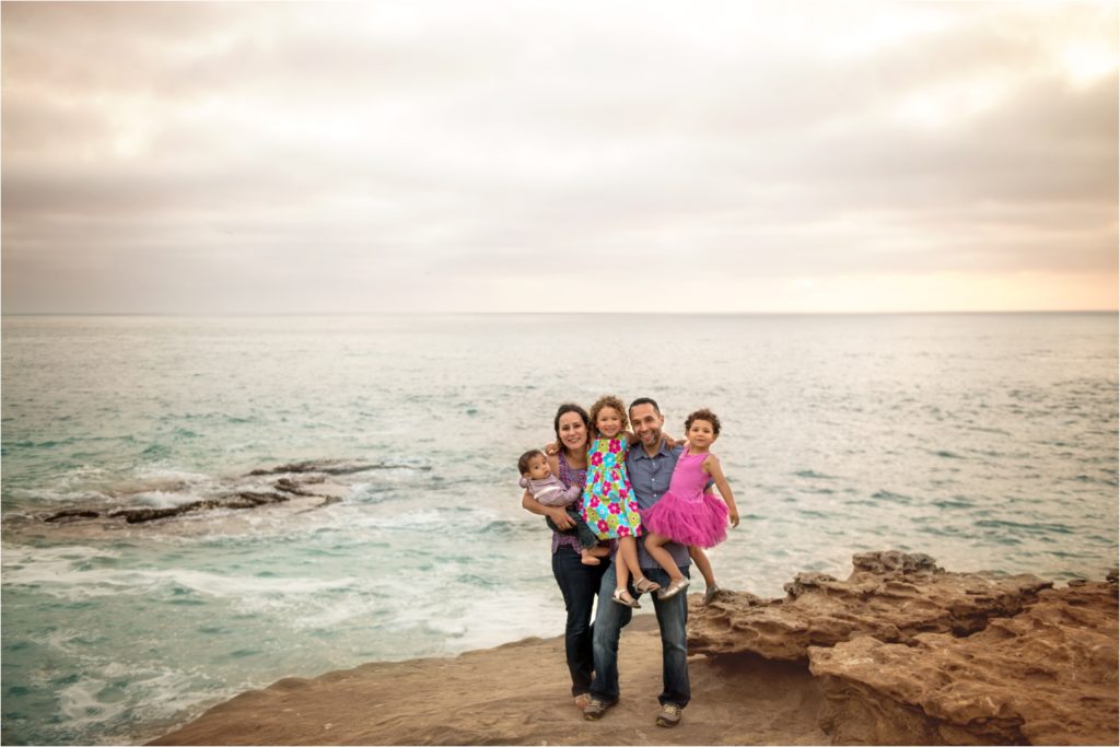 San Diego Family Photographer, Family Portraits San Diego, Windansea Beach, Wind and Sea beach, Family session with three kids . Mother and daughters, mommy and daughter, mother kissing daughter. Family with three kids on the beach, ocean,