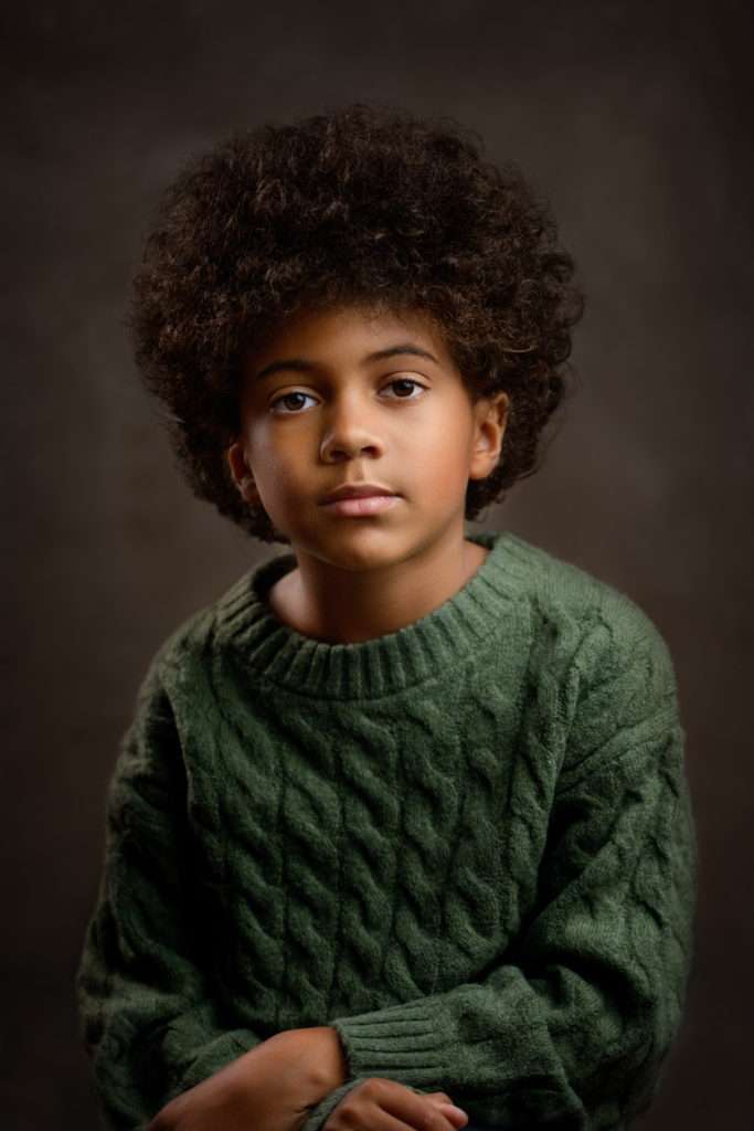 fine art portrait of the african american boy wearing a green sweater at san diego