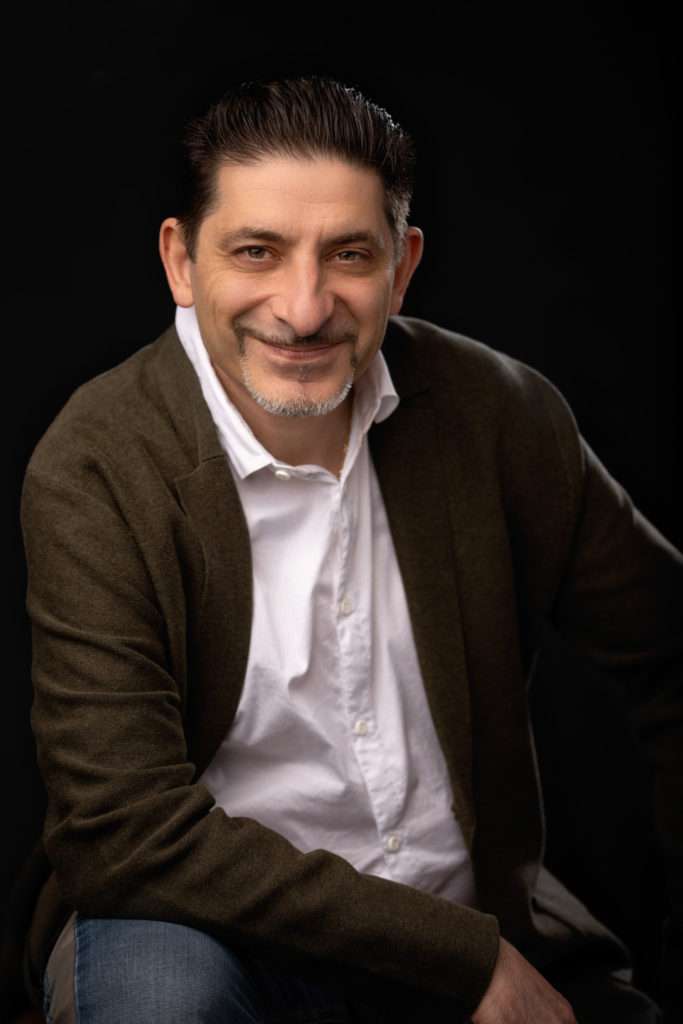 business headshot of a man in brown sweater and white shirt by headshot photographer in san diego