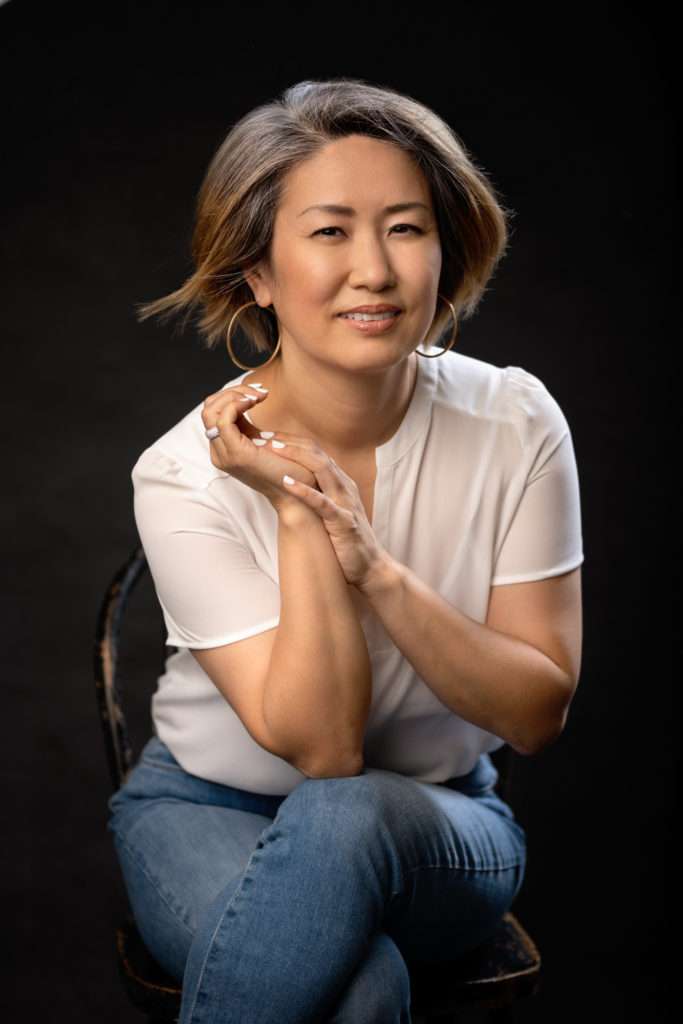 business headshot of a woman in white blouse and jeans in san diego business headshot photo studio