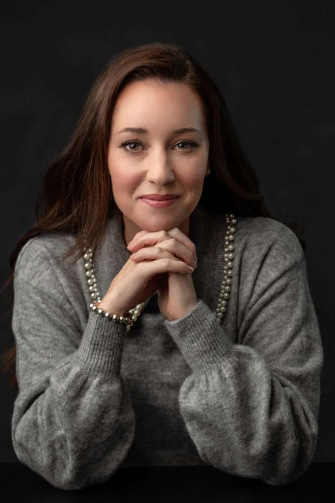 profesional headshot of a beautiful woman wearing grey sweater by san diego headshot photographer
