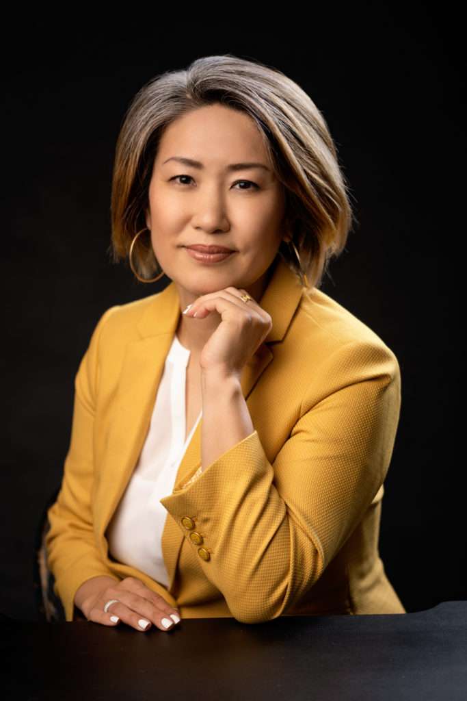 professional headshot of a woman wearing mustard jacket and white shirt by san diego professional headshots