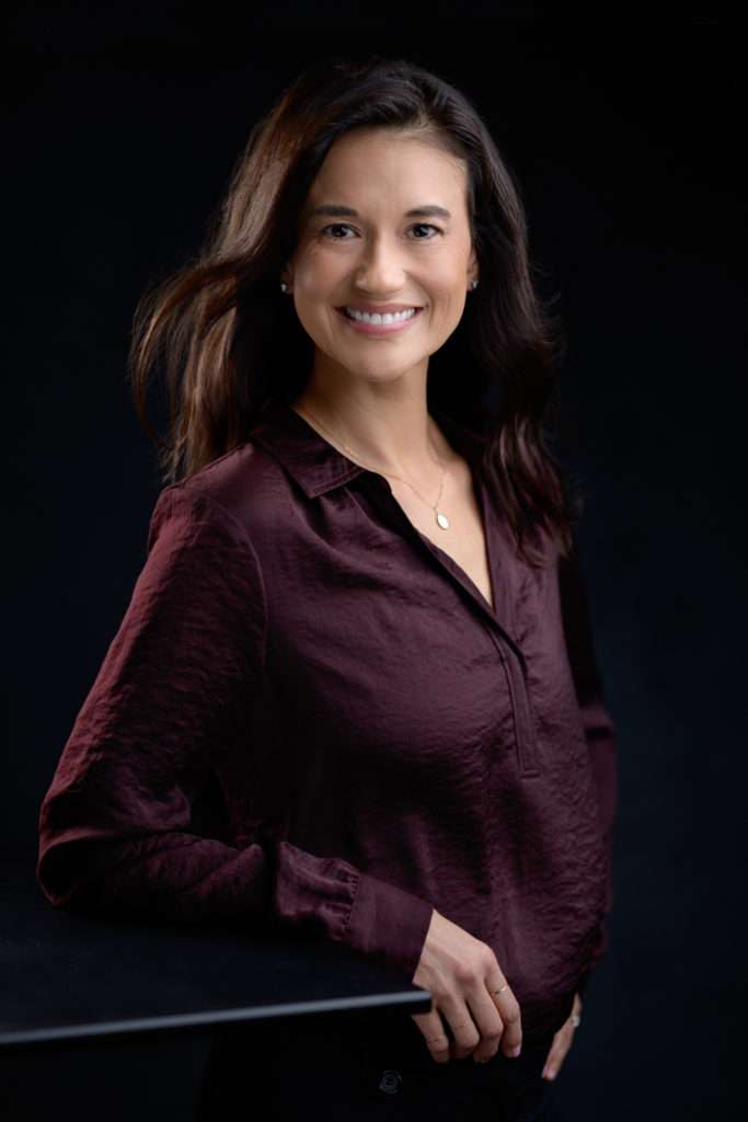 business headshot of a woman in blown blouse and black hair by san diego business headshot photographer